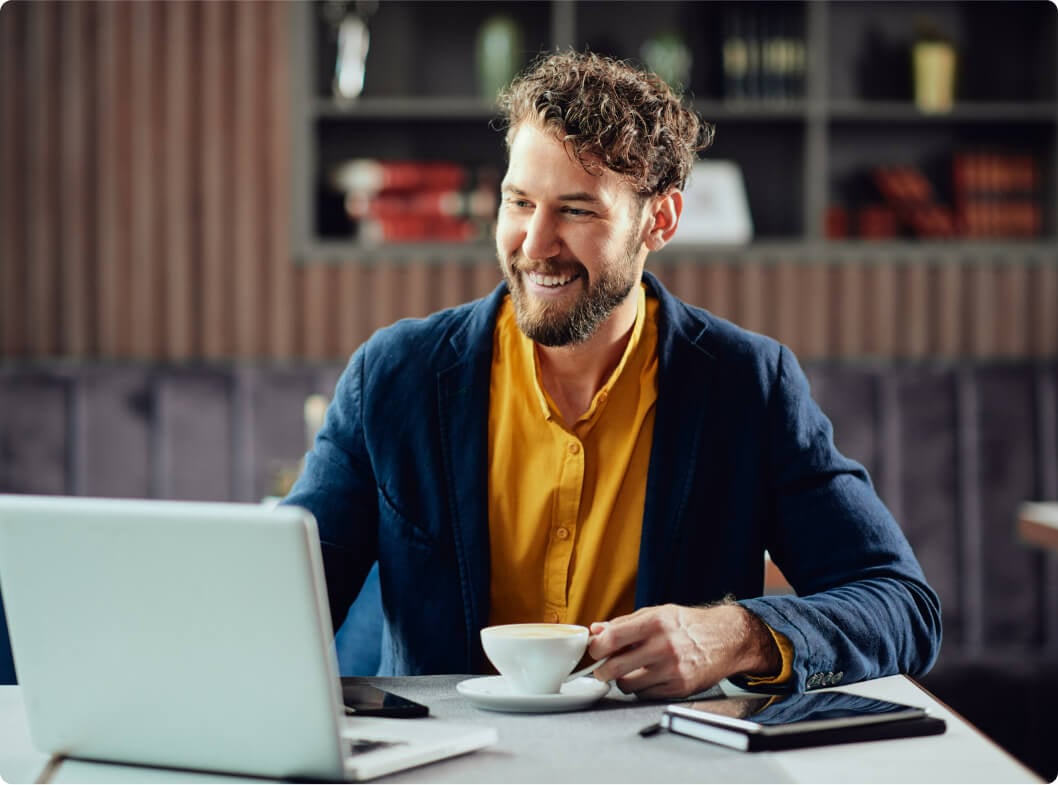 Businessman using laptop to automate mortgage lifecycle.
